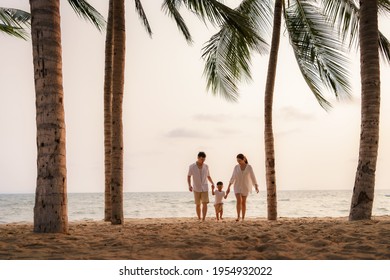 Asian family with fathers, mother and son are walking along a beachfront beach with coconut trees while on vacation in the summer in Thailand.
 - Powered by Shutterstock