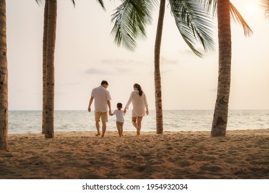 Asian family with fathers, mother and son are walking along a beachfront beach with coconut trees while on vacation in the summer in Thailand.
 - Powered by Shutterstock