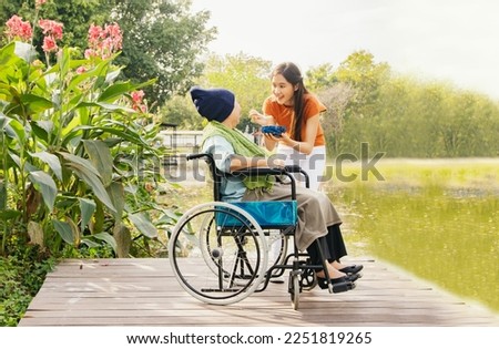 Similar – Older woman in a wheelchair