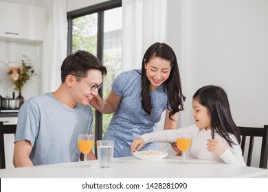 Asian Family Happy Enjoy Having Breakfast On Table In Kitchen