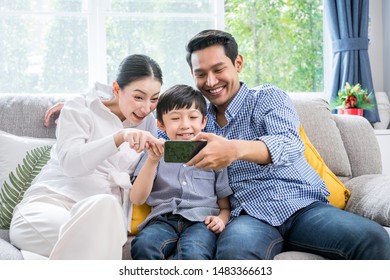 Asian Family Happy With Internet Technology On Smartphone Together