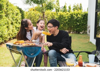 Asian family having a barbecue party at home. Cooking grilled bbq for dinner in backyard. Lifestyle on holiday. - Powered by Shutterstock