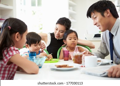 Asian Family Having Breakfast Before Husband Goes To Work