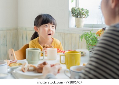 Asian Family Having Breakfast With Conversation