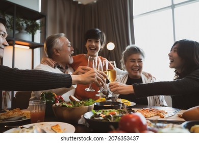 Asian family having dinner at dining table at home - Powered by Shutterstock