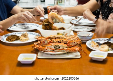 Asian Family Having Dinner With Fresh Steamed Blue Crabs Seafood At Home. Indoor