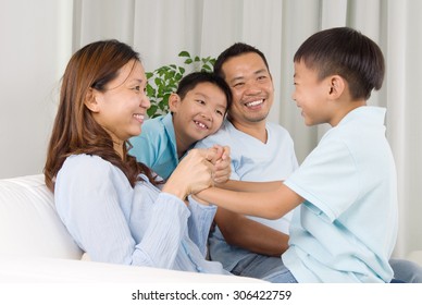 Asian Family Having Fun At Home