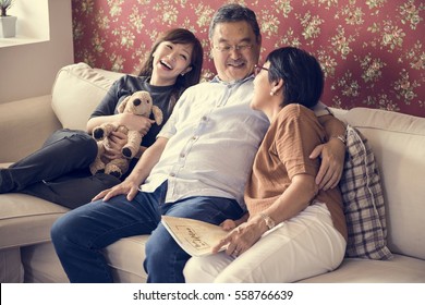 Asian family having fun in the living room together