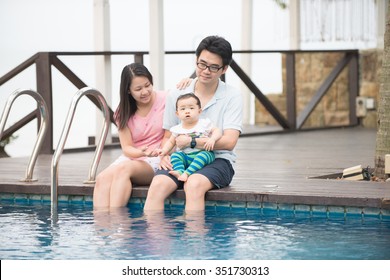 Asian Family Having Fun At The Pool