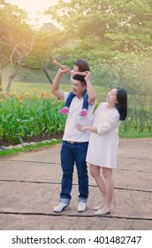 Asian Family Having Morning Walk In The Beautiful Sunshine