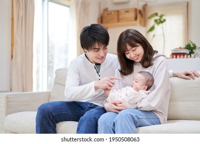 Asian Family Holding A Baby