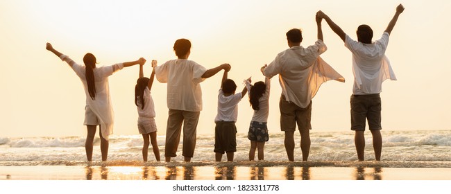 Asian Family Holidays At The Beach. Happy Family In Asia Traveling, Resting After The Virus Crisis, Living Life With Family