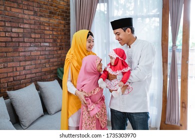 asian family at home celebrating eid mubarak together - Shutterstock ID 1735303970