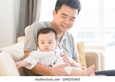 Asian Family At Home. Father Babysitting Son, Living Lifestyle Indoors. 