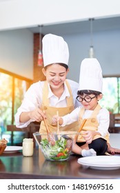 Asian Family In The Kitchen. Mom Teaching Son For Cook Healthy Food In Summer Holiday.