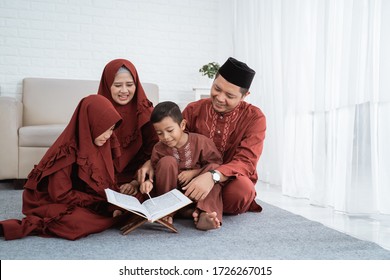 Asian Family Learn Quran Bible Together When Spare Time In The Holiday