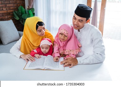 Asian Family Learn Quran Bible Together When Spare Time In The Holiday