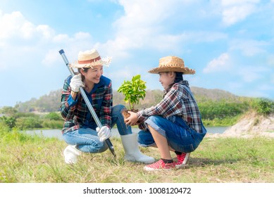 Asian family mom and kid daughter plant sapling tree outdoors in nature spring for reduce global warming growth feature and take care nature earth. People kid girl in garden background - Powered by Shutterstock