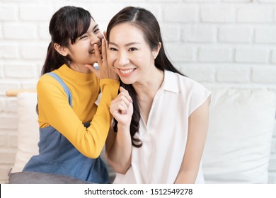 Asian Family Mom And Teenage Daughter Telling Gossip And Sharing In A Room With Nature Sunlight At Home.