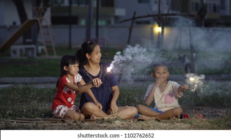 Asian Family, Mother, Son And Daughter, Fireworks Activity At The Park.