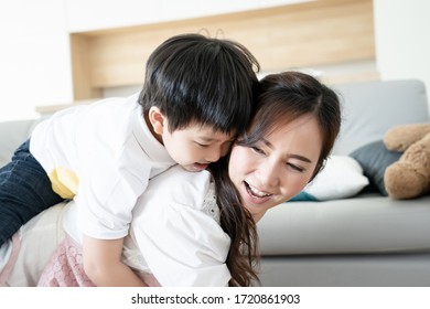 Asian family mother and son happy hug together during playing horse rider, parent and kid is real people family. - Powered by Shutterstock