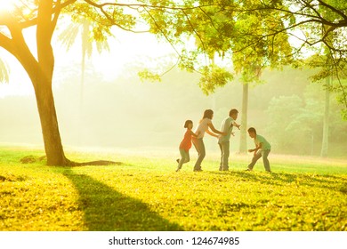 Asian Family Outdoor Quality Time Enjoyment, Asian People Playing During Beautiful Sunrise