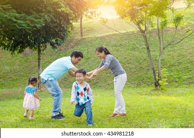 Asian Family Outdoor Quality Time Enjoyment, Asian People Playing During Beautiful Sunset.