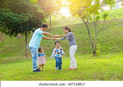 Asian Family Outdoor Quality Time Enjoyment, Asian People Playing During Beautiful Sunset.