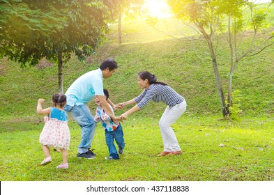 Asian Family Outdoor Quality Time Enjoyment, Asian People Playing During Beautiful Sunset.