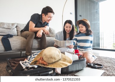 Asian family packing bag/luggage and planning to travel on summer vacation - Powered by Shutterstock