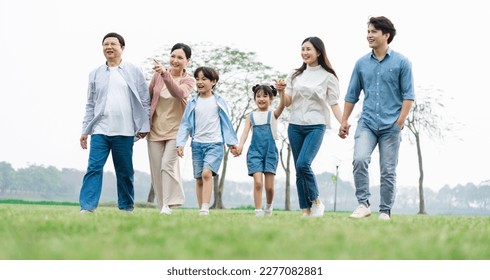 Asian family photo walking together in the park - Powered by Shutterstock