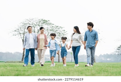 Asian family photo walking together in the park - Powered by Shutterstock