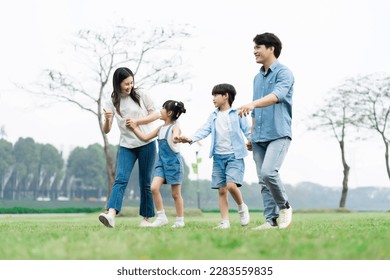 Asian family photo walking together in the park - Powered by Shutterstock