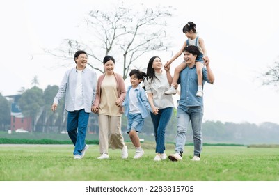 Asian family photo walking together in the park - Powered by Shutterstock