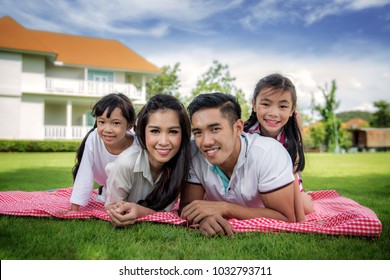 Asian family picnic togater in resort garden, this immage can use for Home, relax, family, park, outdoor, summer, father, mother and kid concept