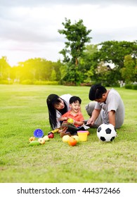 Asian Family Play Together In Garden