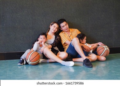 Asian Family Playing Basketball Together