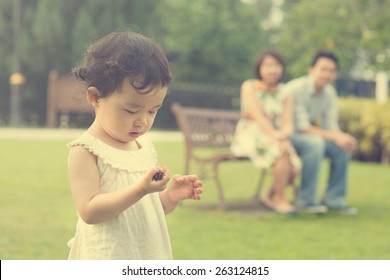 Asian Family Playing And Enjoying Quality Time Outdoor , Vintage Tone