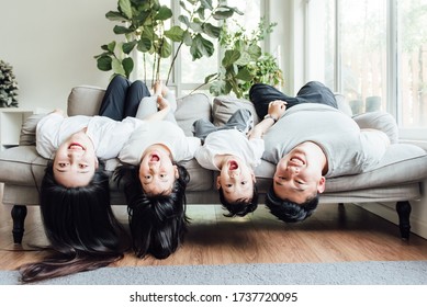 Asian Family Playing In The Living Room