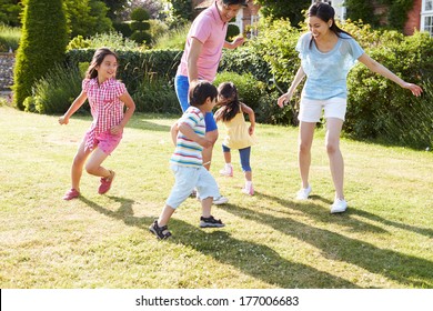 Asian Family Playing In Summer Garden Together