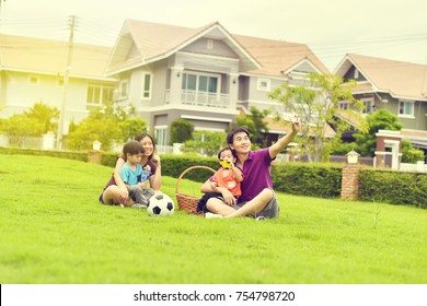 Asian Family Playing Together In Garden