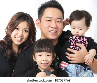 Asian Family portrait inside home with white background