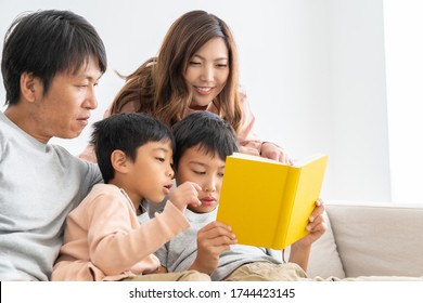 Asian family reading a book - Powered by Shutterstock