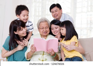 Asian Family Reading Book At Home