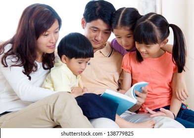 Asian Family Reading Book At Home