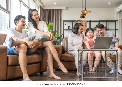 Asian Family Relax Leisure Quarantine Enjoy Weekend Time Together Parent Looking At Grandparent And Grand Child Learn Online With Laptop On Sofa  In Living Room House Interior Concept