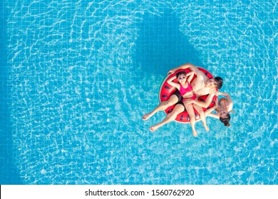 Asian Family Relax In Swimming Pool, This Image Can Use For Summer, Father, Moter, Summer, Water And Sport Concept