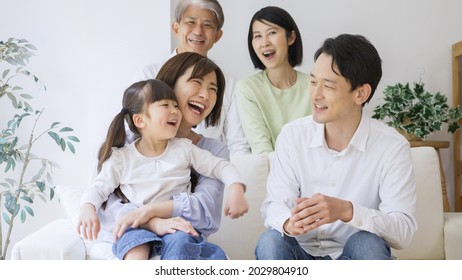 Asian Family Relaxing At Home