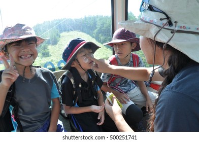 Asian Family In The Ropeway Enjoying Summer Mountain