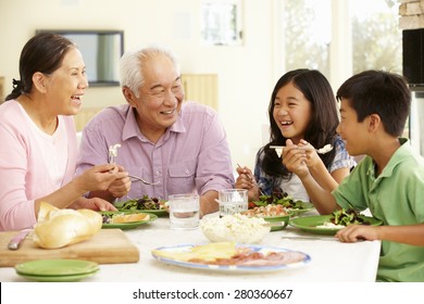 Asian Family Sharing Meal At Home